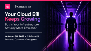 Promotional web banner for a Silk webinar titled "Your Cloud Bill Keeps Growing — But Is Your Infrastructure Actually More Efficient?" Event details show August 18, 2026 at 11:00am ET, with featured customer Cloudgainz. The Silk logo appears in the bottom left corner on a pink background. The right side features a dramatic photo of a person walking away from the camera down a long data center corridor lined with server racks illuminated by purple and pink neon lighting.